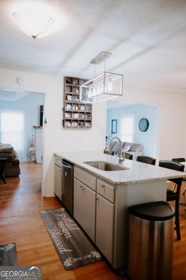 kitchen featuring pendant lighting, stainless steel dishwasher, plenty of natural light, and sink