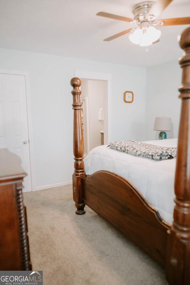 carpeted bedroom with ceiling fan and ensuite bathroom