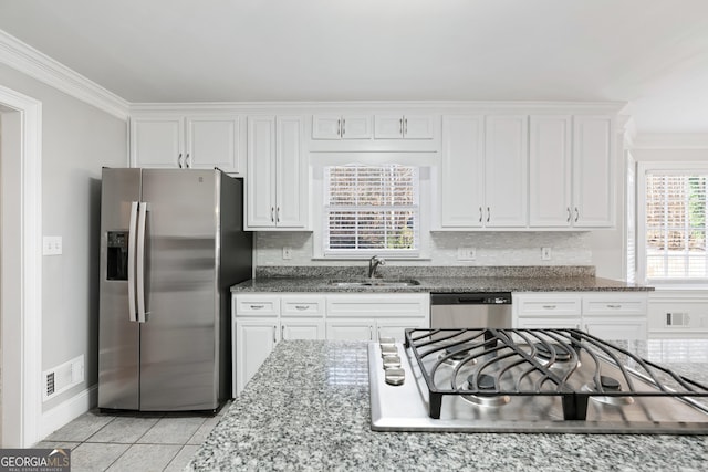 kitchen featuring sink, white cabinets, ornamental molding, and appliances with stainless steel finishes