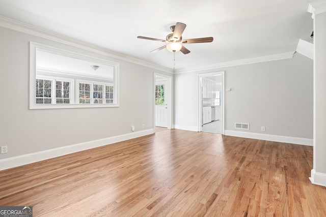 spare room featuring light hardwood / wood-style flooring, ceiling fan, and crown molding