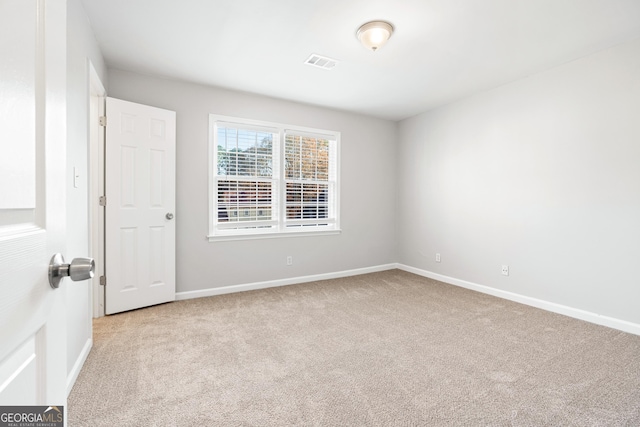 empty room featuring light colored carpet