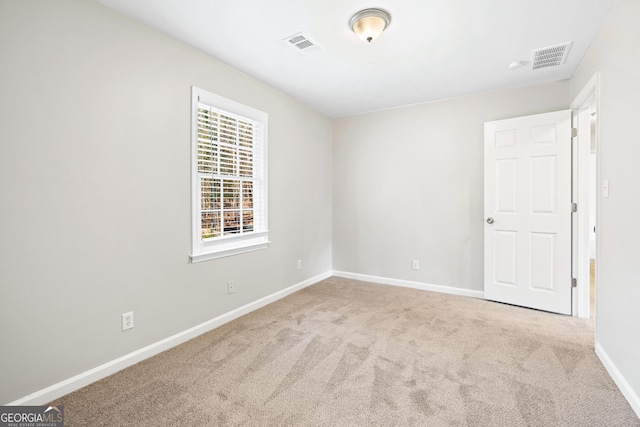 unfurnished room with light carpet