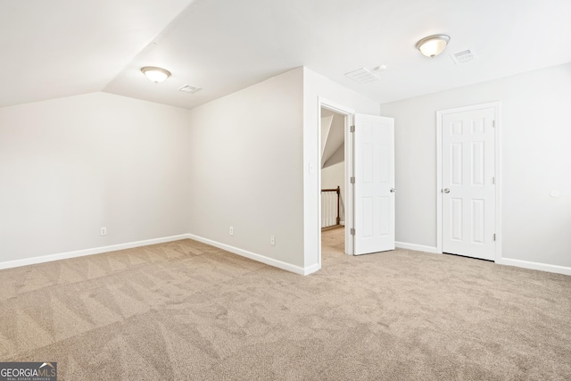 interior space featuring carpet and vaulted ceiling