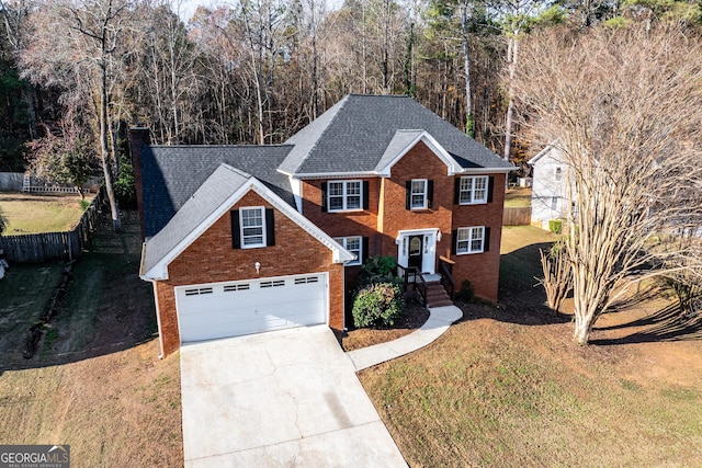 view of front of property with a front yard and a garage