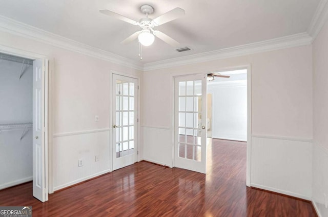 unfurnished room with ceiling fan, french doors, dark hardwood / wood-style floors, and ornamental molding