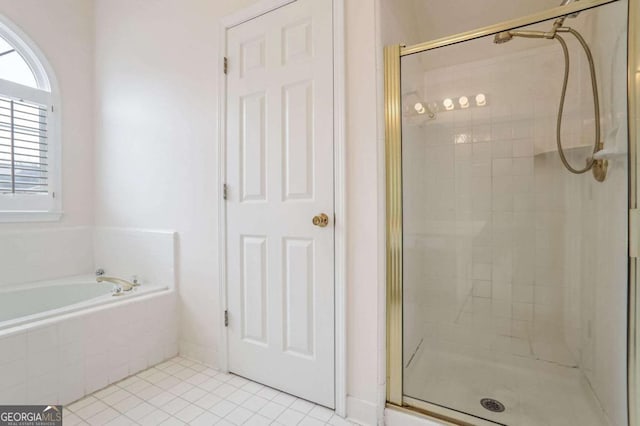 bathroom featuring tile patterned floors and independent shower and bath