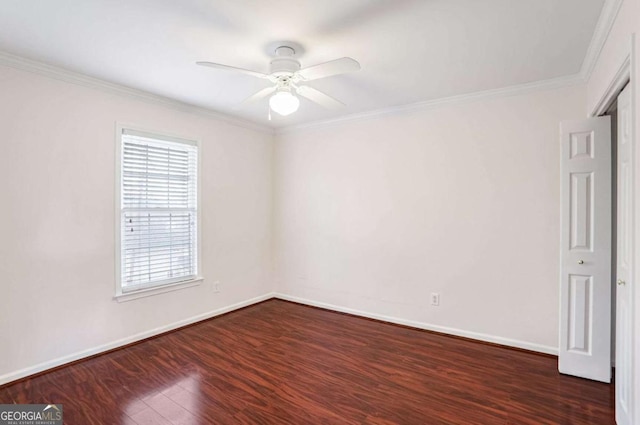 empty room with crown molding, ceiling fan, and dark wood-type flooring