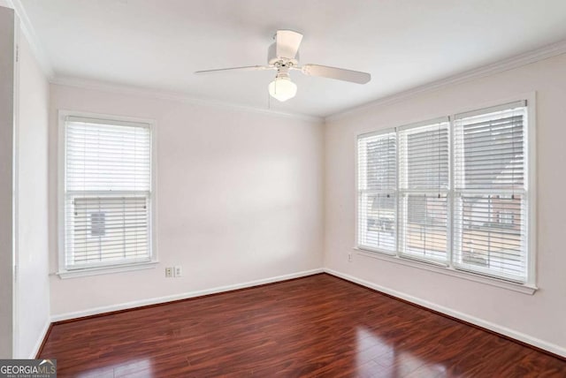 empty room with dark hardwood / wood-style flooring, ceiling fan, plenty of natural light, and ornamental molding