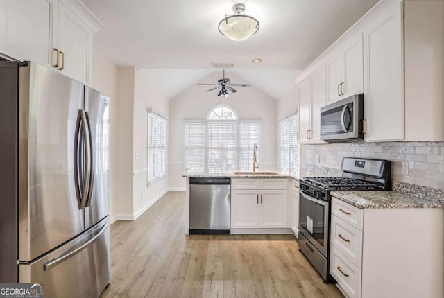 kitchen with ceiling fan, sink, appliances with stainless steel finishes, white cabinets, and light wood-type flooring