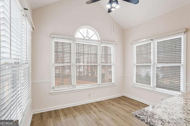 interior space featuring ceiling fan, light hardwood / wood-style flooring, and vaulted ceiling