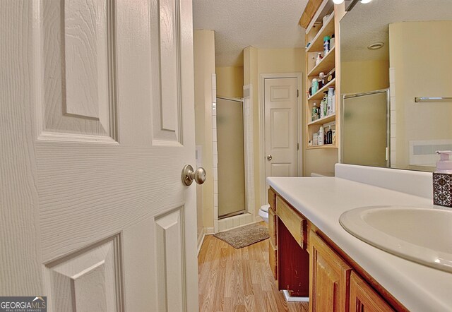 2020 Moore Rd, Moreland, GA 30259 - full bathroom with vanity, a textured ceiling, wood finished floors, and a shower stall