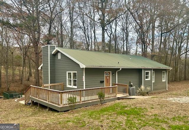 2020 Moore Rd, Moreland, GA 30259 - ranch-style house featuring a deck, cooling unit, a chimney, and metal roof