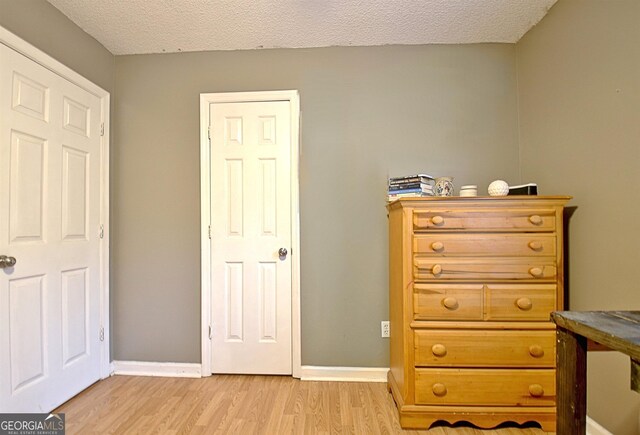 2020 Moore Rd, Moreland, GA 30259 - bedroom featuring light wood-type flooring, a textured ceiling, and baseboards