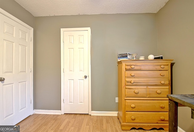 2020 Moore Rd, Moreland, GA 30259 - bedroom with light wood-style flooring and a textured ceiling