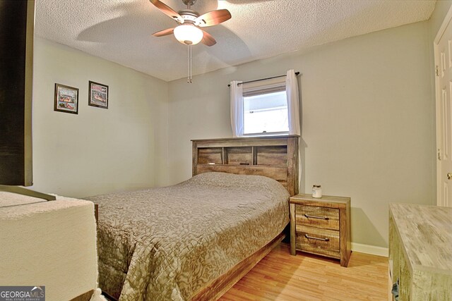 2020 Moore Rd, Moreland, GA 30259 - bedroom featuring baseboards, a ceiling fan, a textured ceiling, and light wood-style flooring