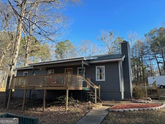 2020 Moore Rd, Moreland, GA 30259 - back of property with a chimney, a deck, and stairway