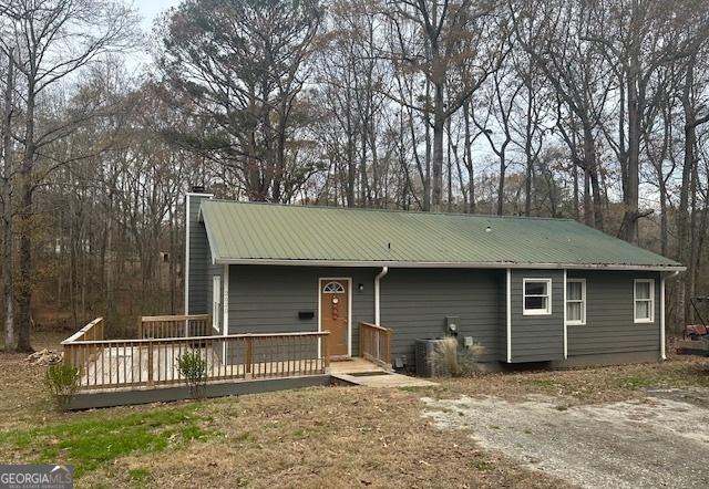 ranch-style home with cooling unit and a deck