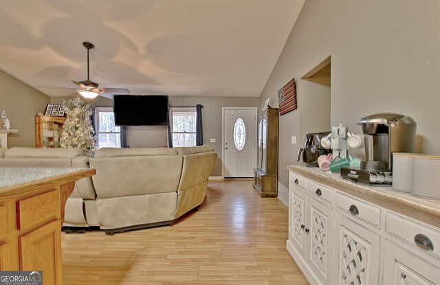 2020 Moore Rd, Moreland, GA 30259 - living room with light wood-type flooring, baseboards, ceiling fan, and vaulted ceiling
