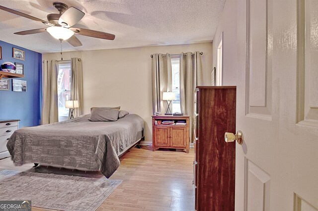 2020 Moore Rd, Moreland, GA 30259 - bedroom with light wood-style floors, a ceiling fan, and a textured ceiling