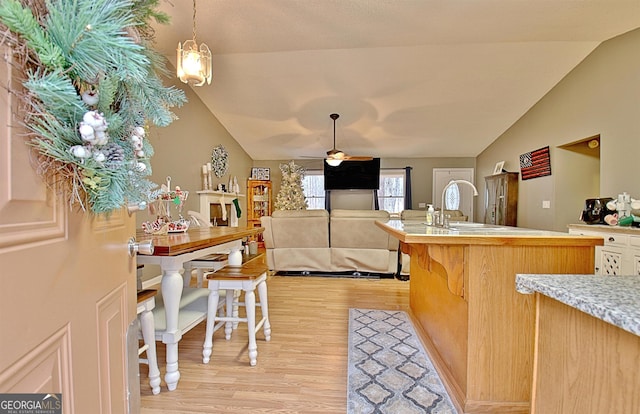 2020 Moore Rd, Moreland, GA 30259 - kitchen with vaulted ceiling, light wood-type flooring, ceiling fan, light countertops, and a center island