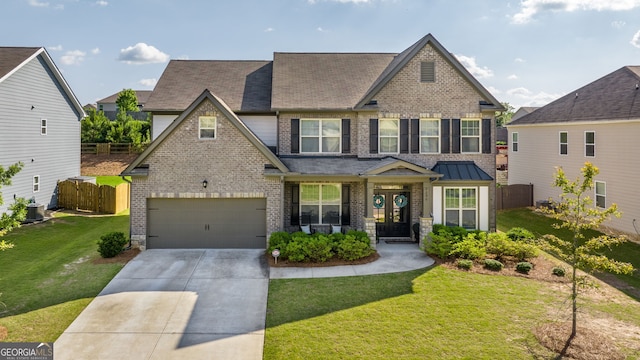 view of front of property featuring a front lawn and a garage