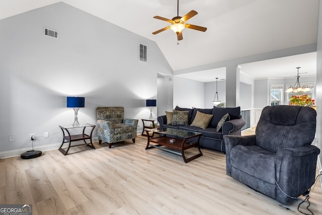 living room featuring ceiling fan with notable chandelier, light wood-type flooring, and high vaulted ceiling