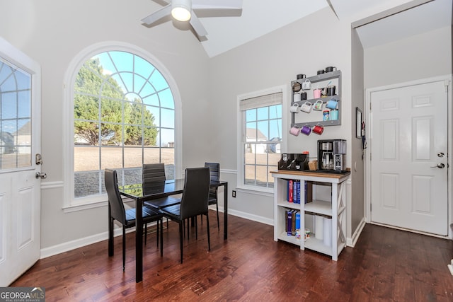 dining room with lofted ceiling, dark wood-style floors, baseboards, and a ceiling fan