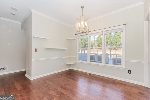 unfurnished dining area featuring dark hardwood / wood-style flooring, crown molding, and a notable chandelier