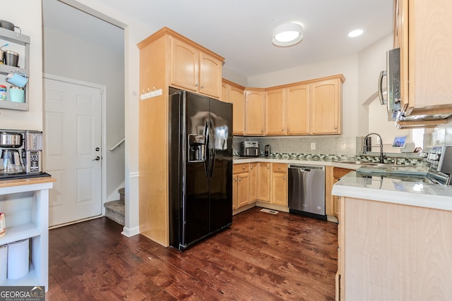 kitchen with light brown cabinets, appliances with stainless steel finishes, light countertops, and a sink