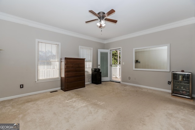 unfurnished bedroom featuring light carpet, access to outside, ceiling fan, and crown molding