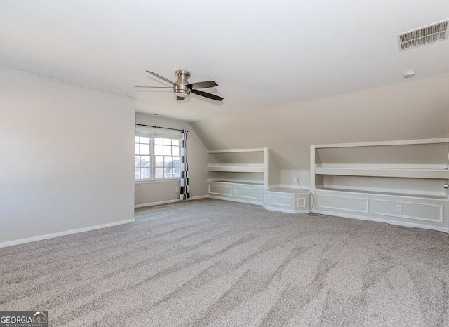 additional living space with light carpet, vaulted ceiling, and ceiling fan