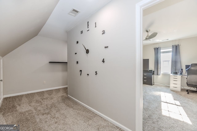 additional living space with light carpet and vaulted ceiling