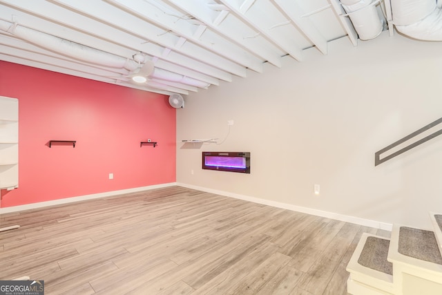 finished basement with baseboards and wood finished floors