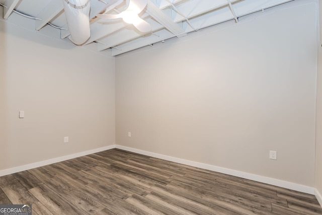 empty room featuring baseboards and wood finished floors