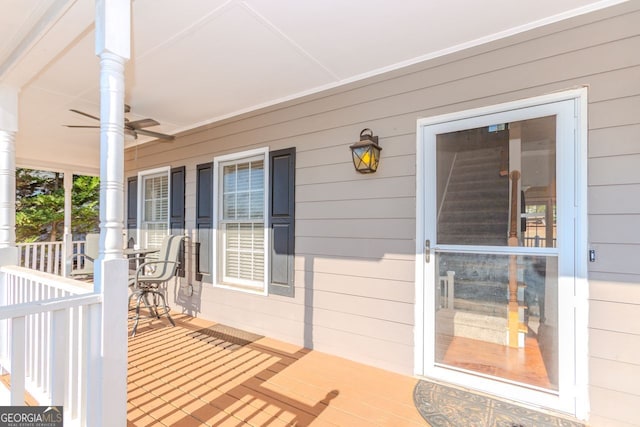 wooden deck featuring ceiling fan and covered porch