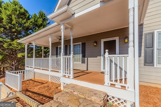 view of exterior entry with ceiling fan and a porch