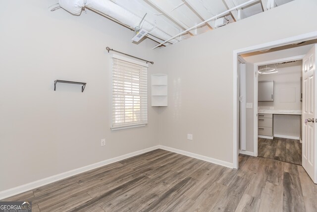 bathroom featuring hardwood / wood-style floors, decorative backsplash, toilet, and vanity