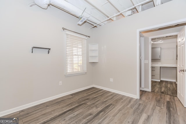 interior space featuring baseboards and wood finished floors