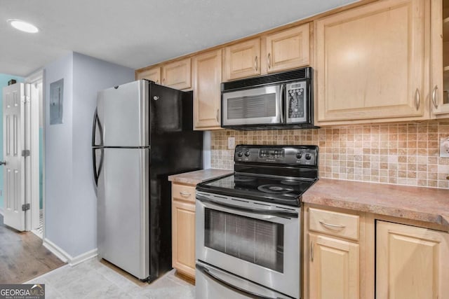 kitchen featuring decorative backsplash, light brown cabinets, and appliances with stainless steel finishes