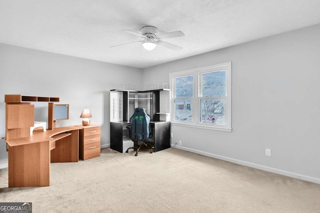 home office with light carpet and ceiling fan