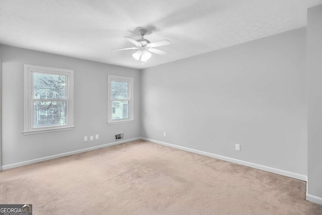 empty room featuring ceiling fan and carpet floors