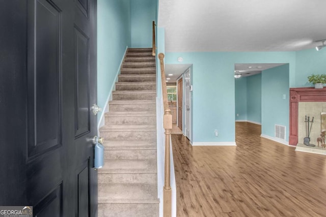 stairway featuring wood-type flooring