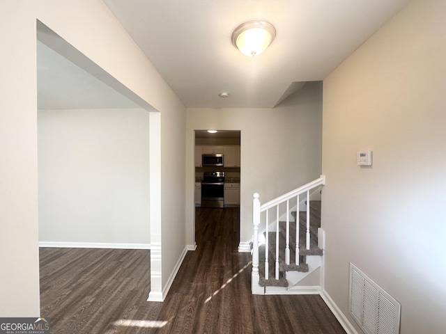 hallway with dark wood-type flooring