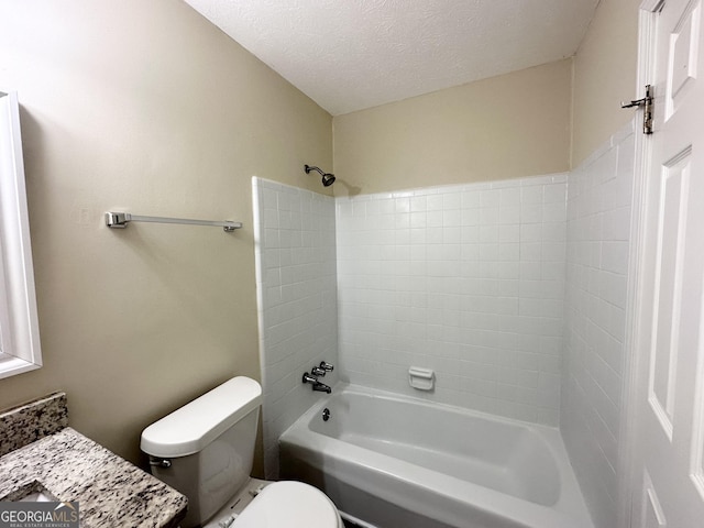 bathroom featuring toilet, washtub / shower combination, and a textured ceiling