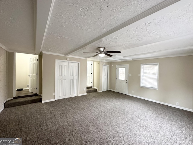 unfurnished bedroom featuring beamed ceiling, a textured ceiling, dark carpet, and ceiling fan