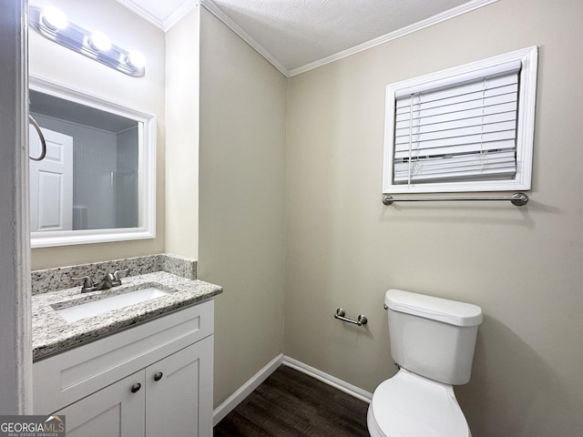 bathroom with toilet, hardwood / wood-style floors, vanity, and ornamental molding