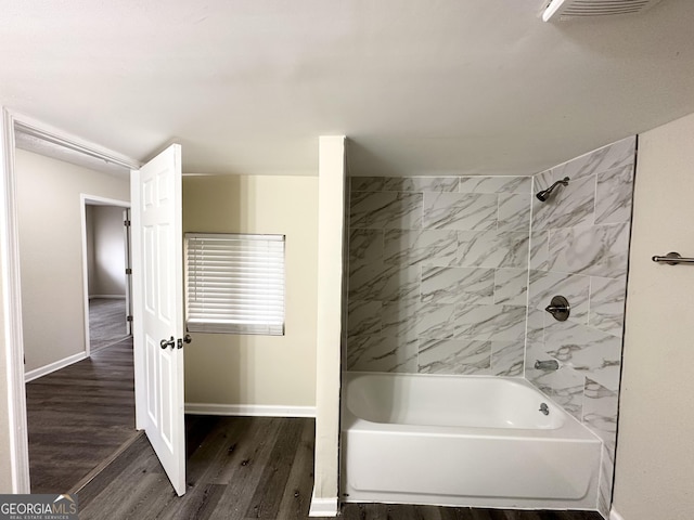 bathroom featuring hardwood / wood-style floors and tiled shower / bath combo