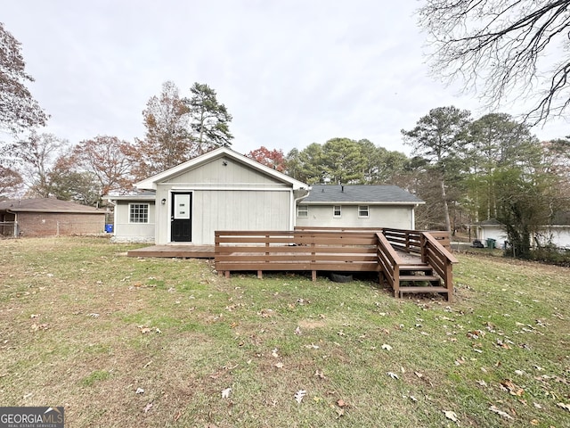 back of property featuring a yard and a deck