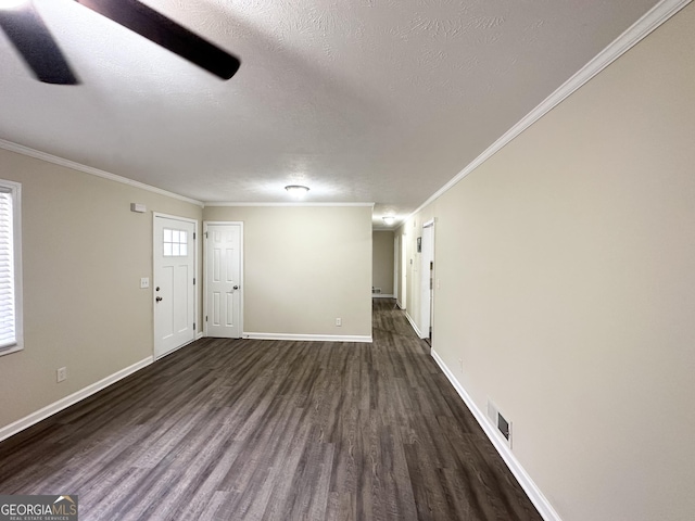 interior space featuring a textured ceiling, dark hardwood / wood-style flooring, and crown molding