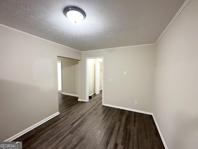 unfurnished room featuring dark wood-type flooring, a textured ceiling, and ornamental molding